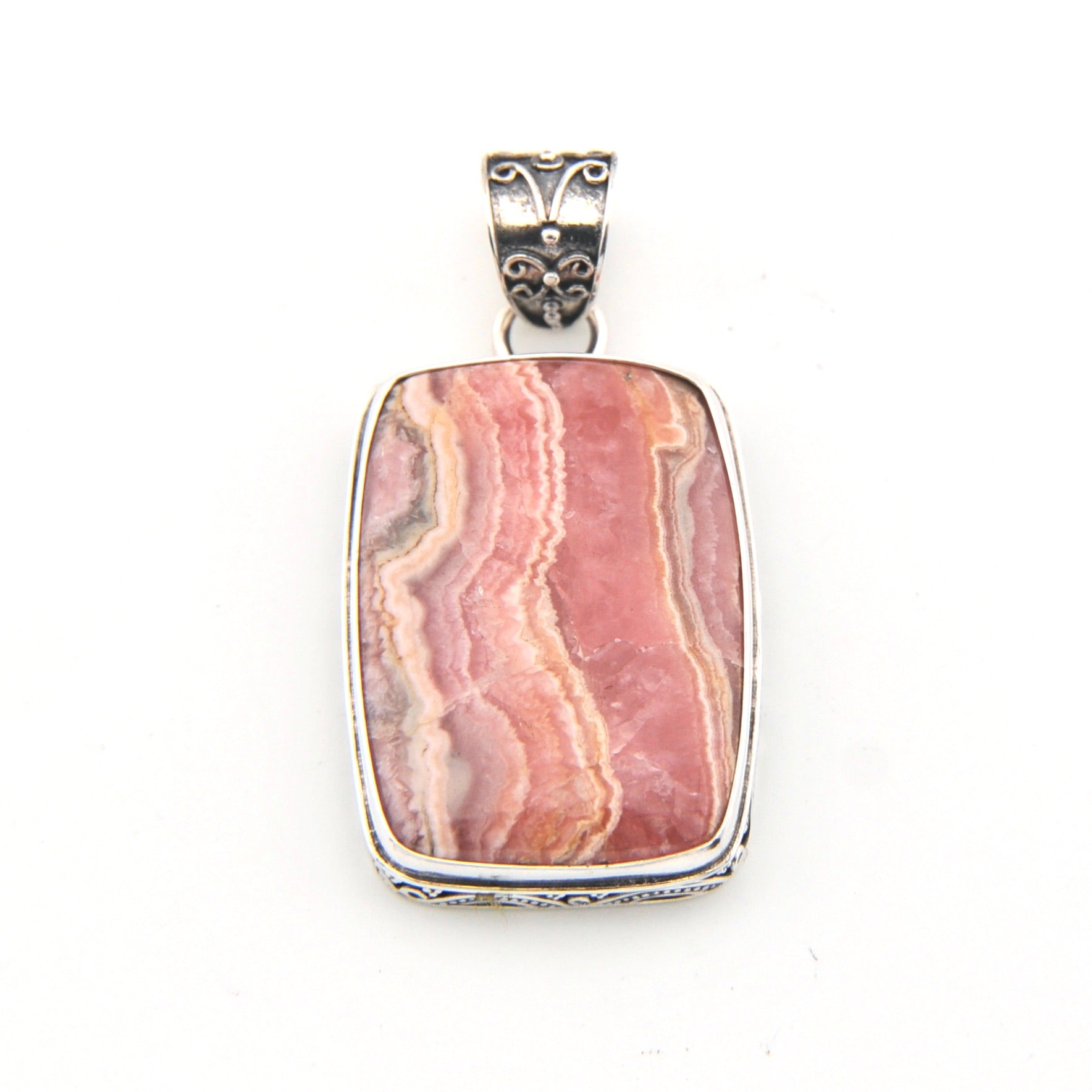 Pink stone pendant with silver setting on a white background