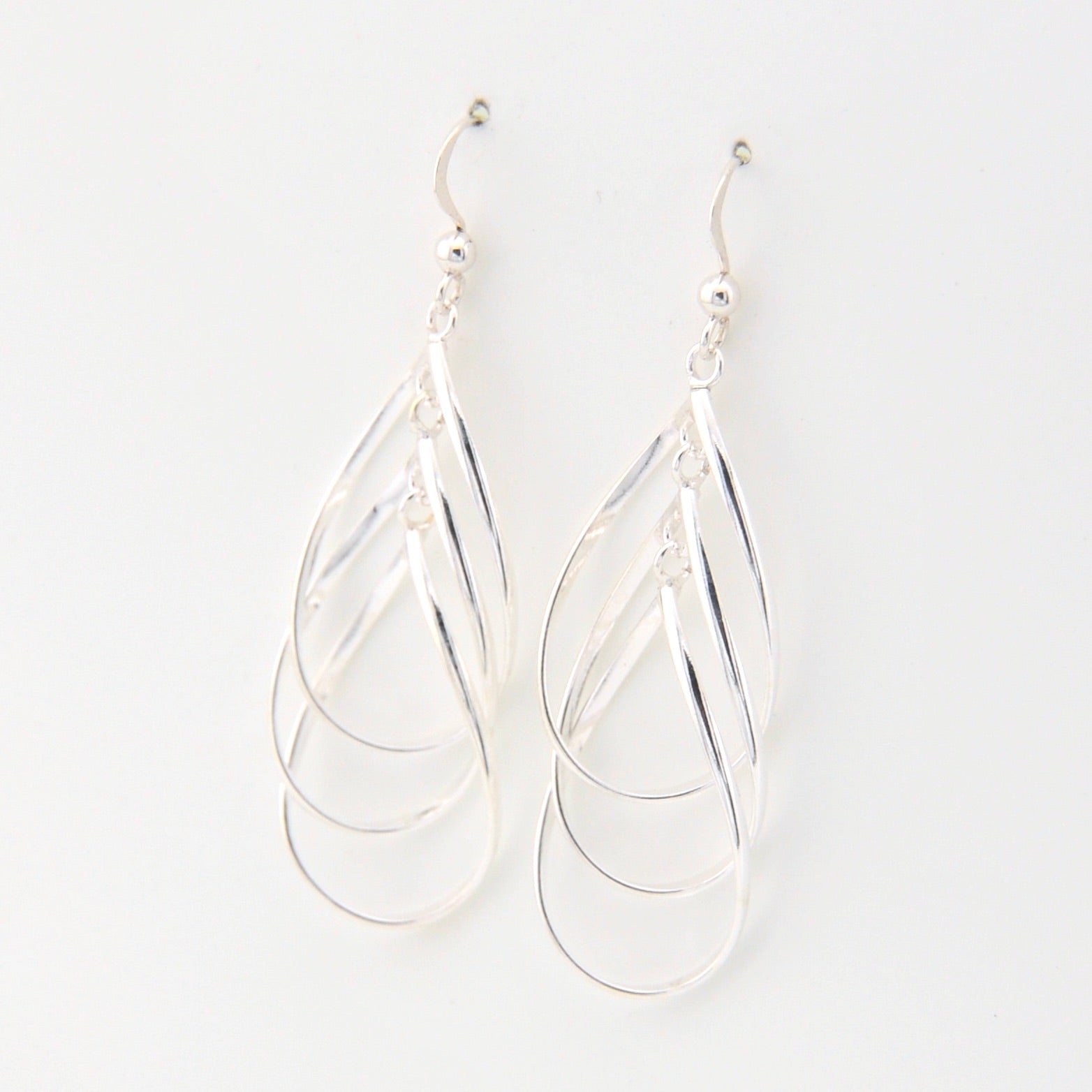 Silver teardrop earrings on a white background