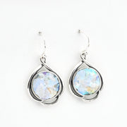Silver earrings with round glass on a white background