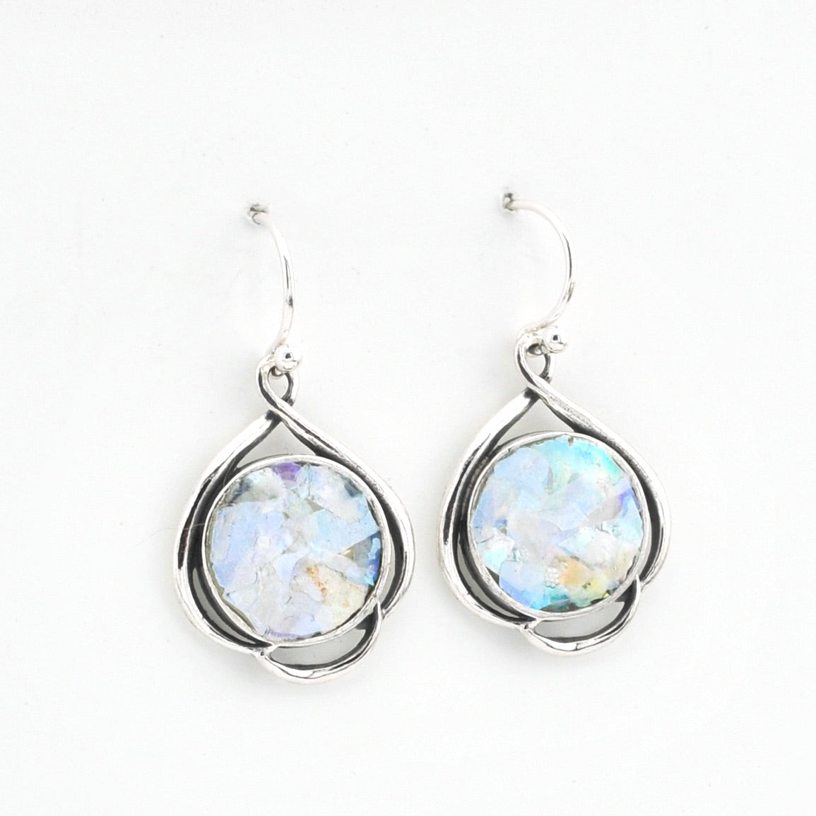 Silver earrings with round glass on a white background