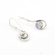 Silver earrings with a round gemstone on a white background