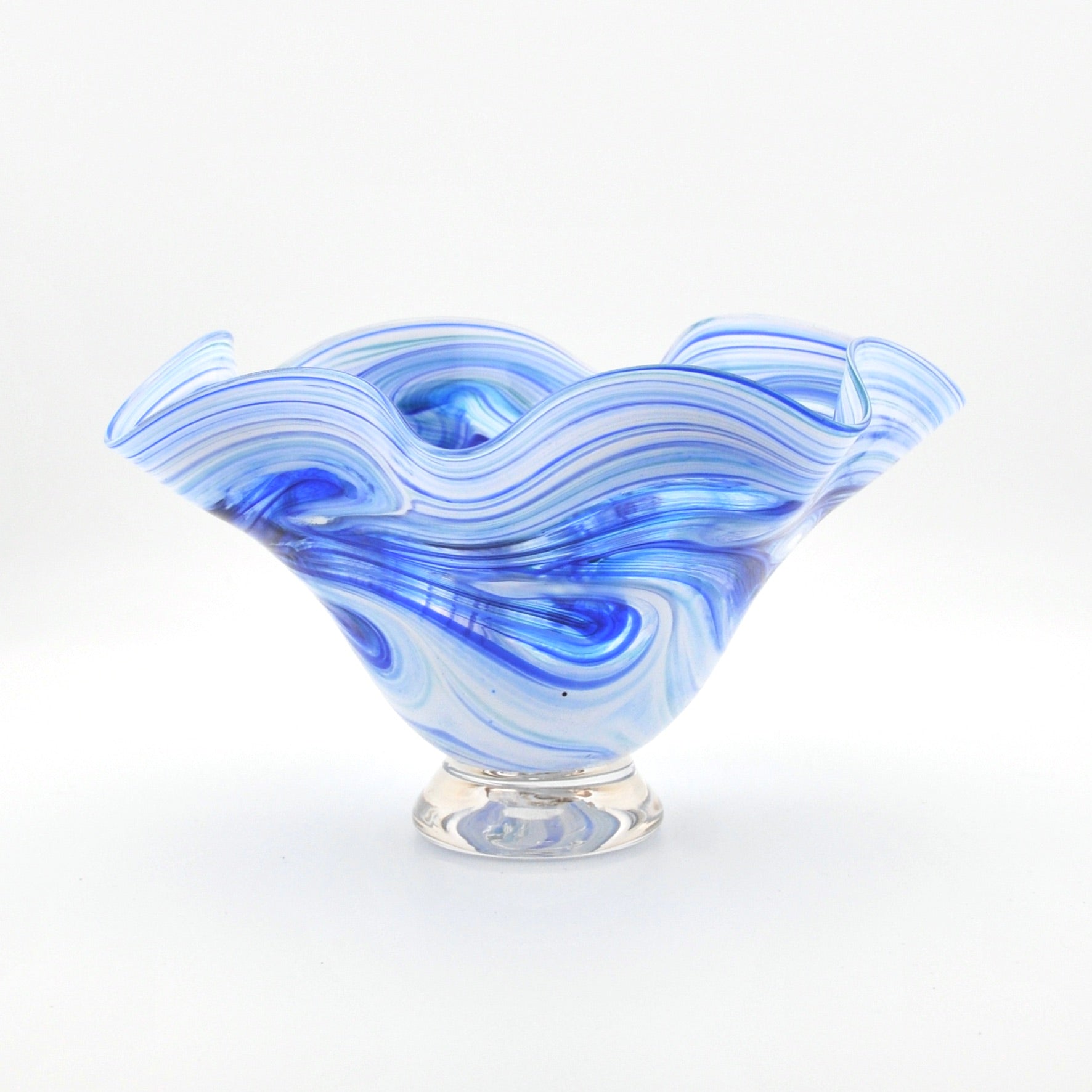Blue and white glass bowl with wavy design on a white background