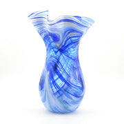 Blue and white swirled glass vase on a white background