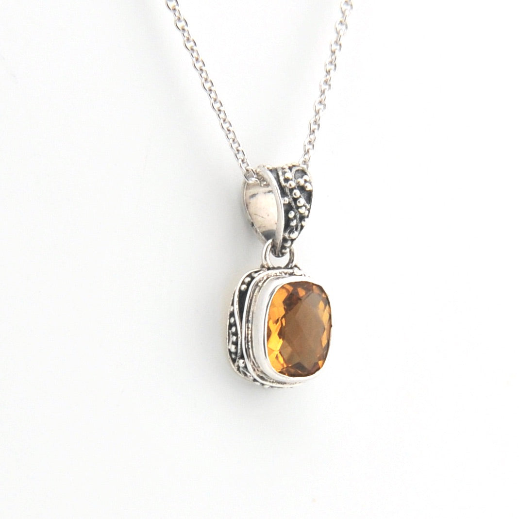 Silver pendant with a smoky quartz stone on a white background