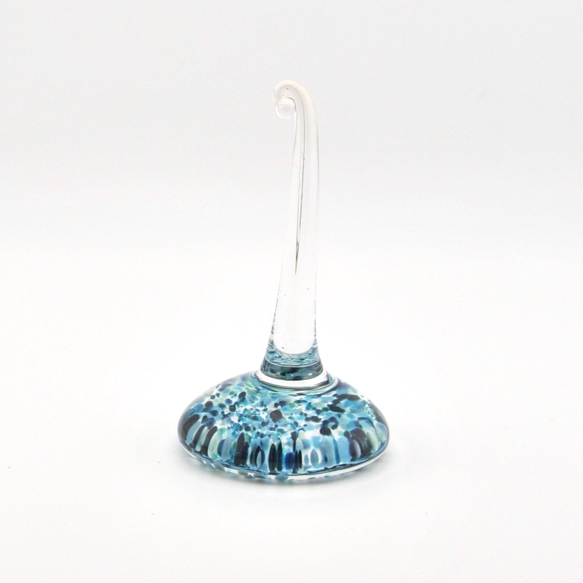 Glass ring holder with blue and white speckled design on a white background