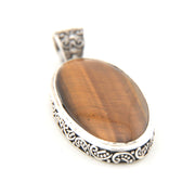 Tiger's eye stone pendant with silver decorative frame on a white background