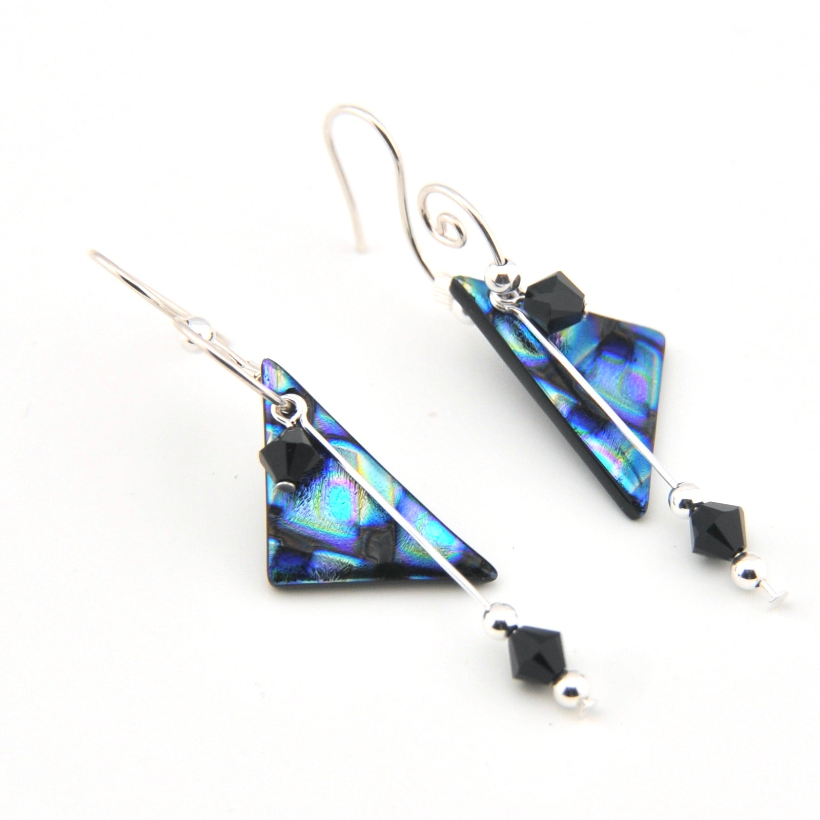 Pair of triangular earrings with black beads on a white background