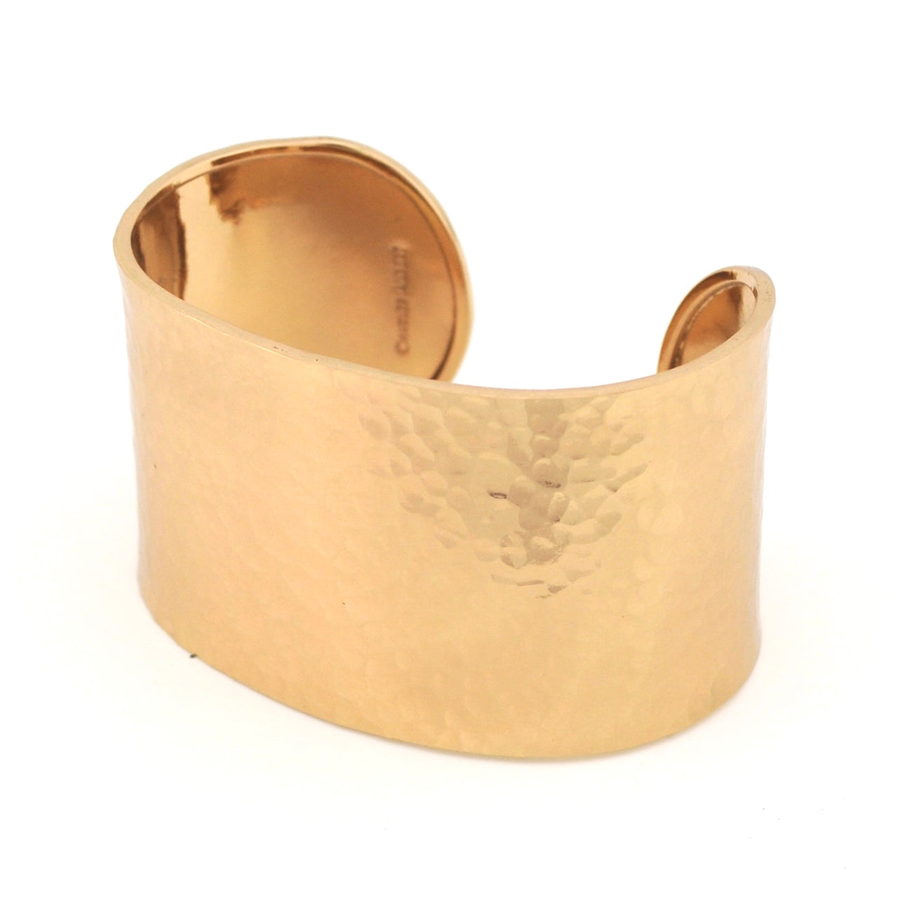 Gold cuff bracelet on a white background