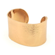 Gold cuff bracelet on a white background