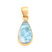 Gold pendant with a blue marbled stone on a white background