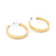 Gold hoop earrings on a white background