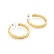Gold hoop earrings on a white background