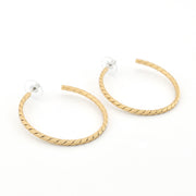 Gold hoop earrings on a white background