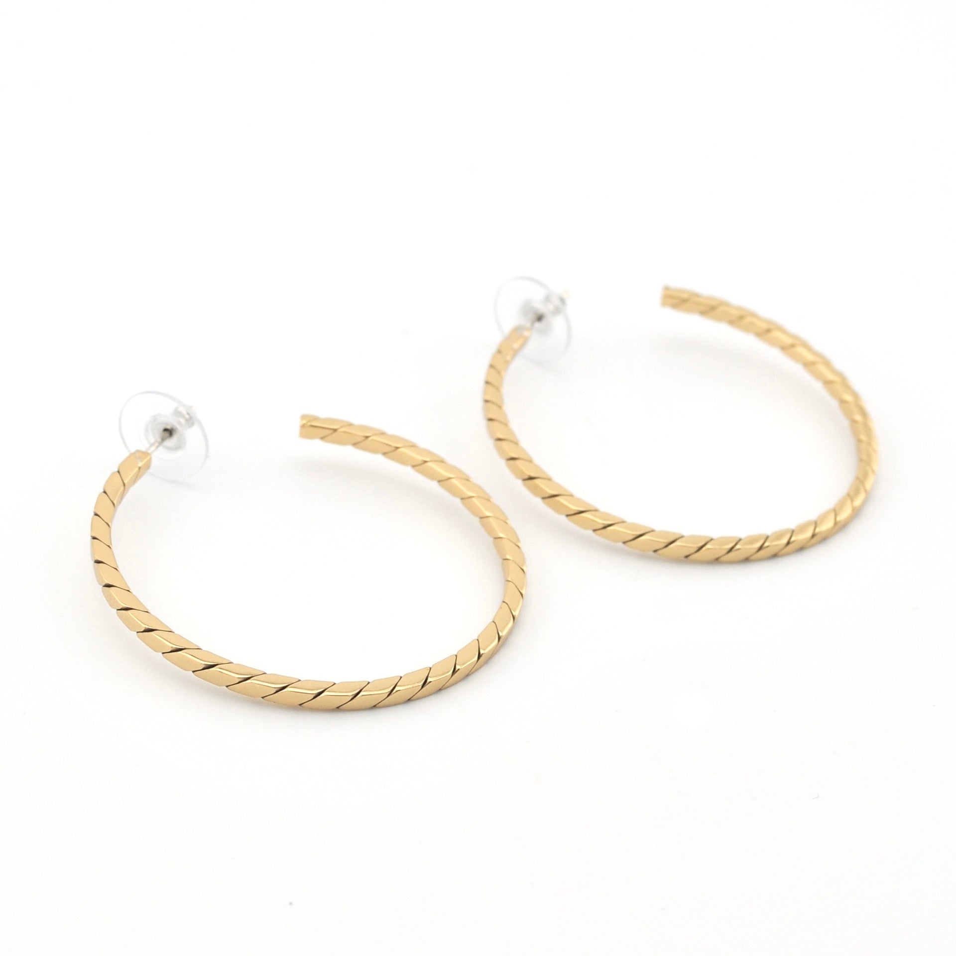 Gold hoop earrings on a white background