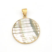 Gold pendant with a circular, textured white stone on a white background