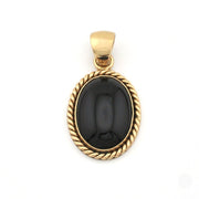 Gold pendant with a black stone on a white background