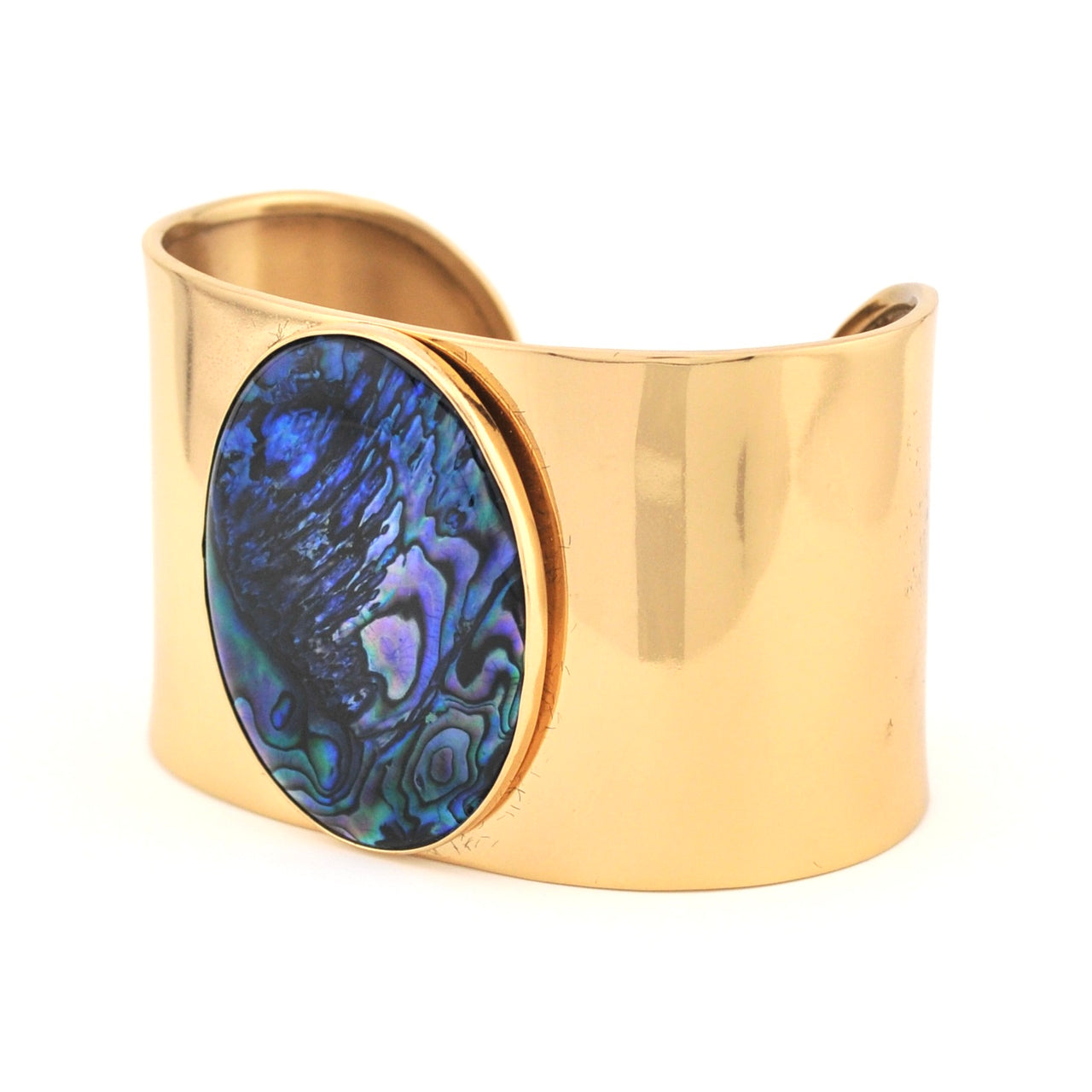Gold cuff bracelet with a blue paua shell inset on a white background