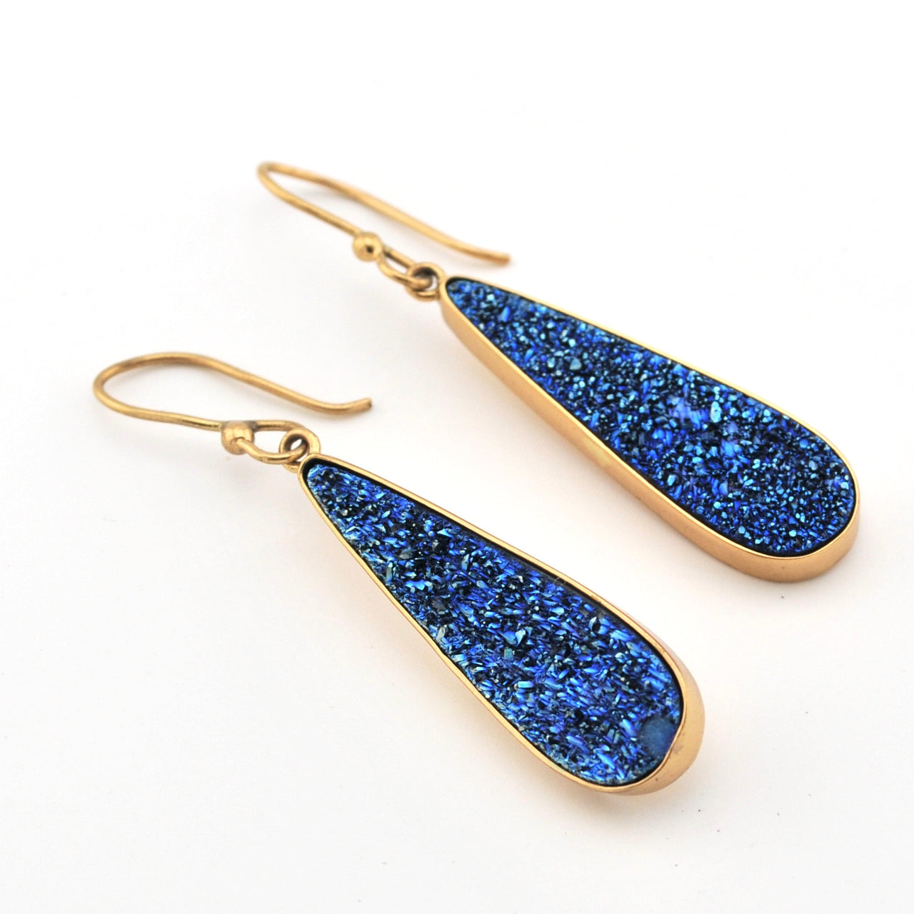 Blue teardrop earrings with gold hooks on a white background