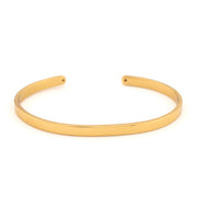 Gold bangle on a white background