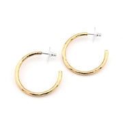 Gold hoop earrings on a white background