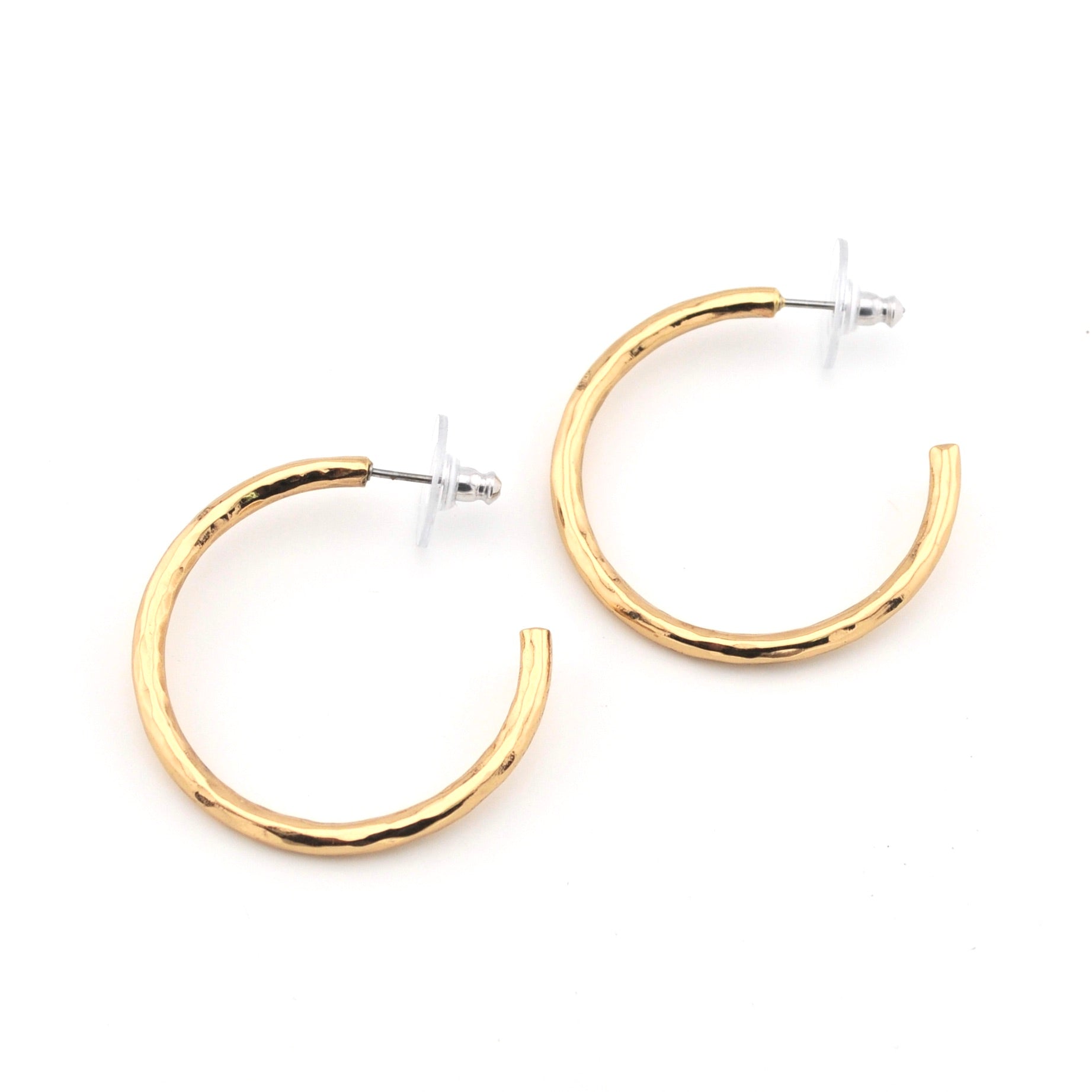 Gold hoop earrings on a white background