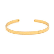 Gold bangle on a white background
