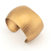 Gold cuff bracelet on a white background