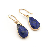 Gold earrings with blue teardrop-shaped stones on a white background