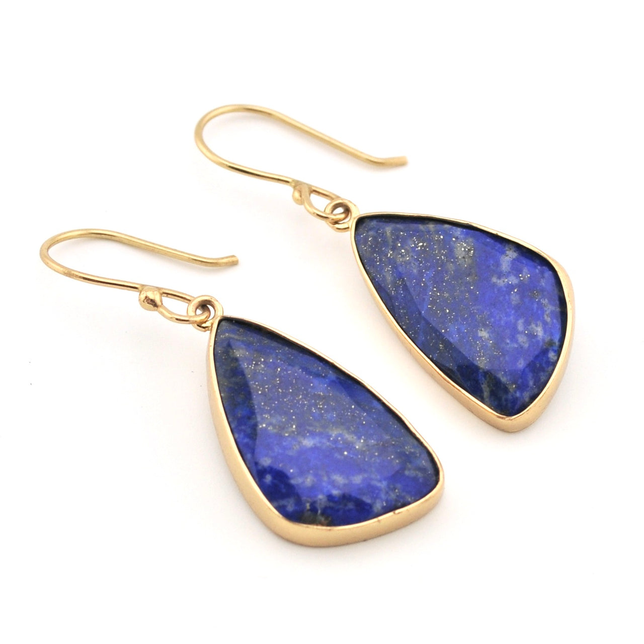 Gold earrings with blue teardrop-shaped stones on a white background