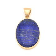 Gold pendant with a blue stone on a white background