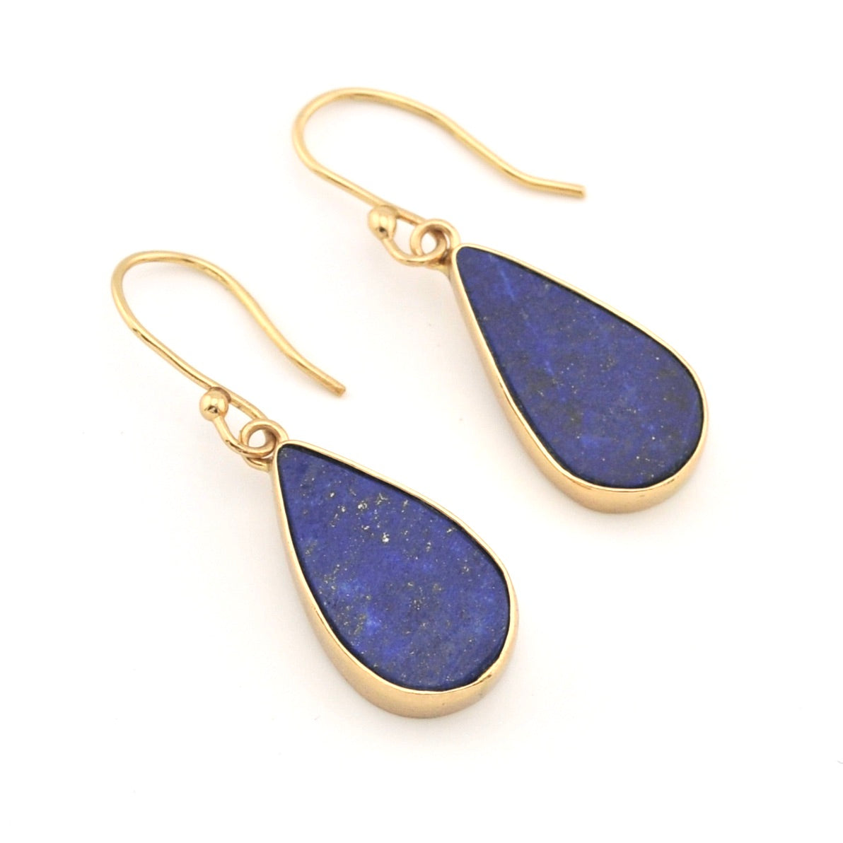 Gold earrings with blue teardrop-shaped stones on a white background