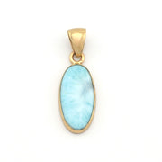 Gold pendant with a light blue stone on a white background