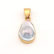 Gold pendant with a large pearl on a white background