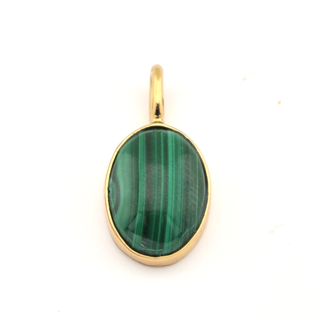 Gold pendant with a green stone on a white background