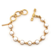 Gold bracelet with pearls on a white background