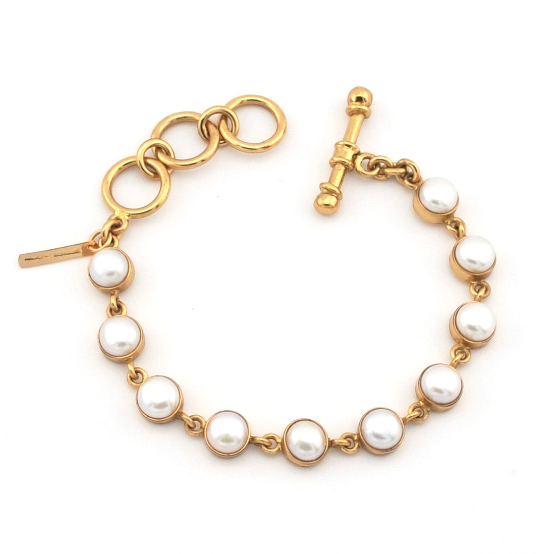 Gold bracelet with pearls on a white background