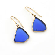 Blue triangular earrings with gold hooks on a white background