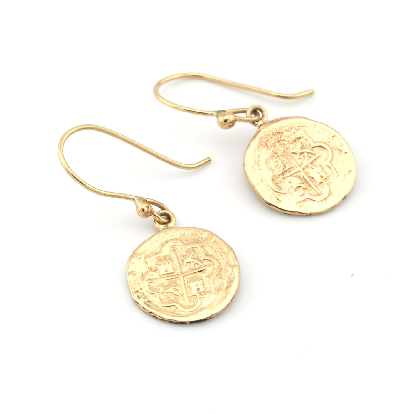Gold coin-shaped earrings on a white background