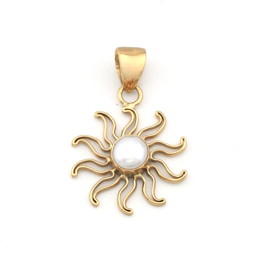 Gold sun-shaped pendant with a pearl center on a white background