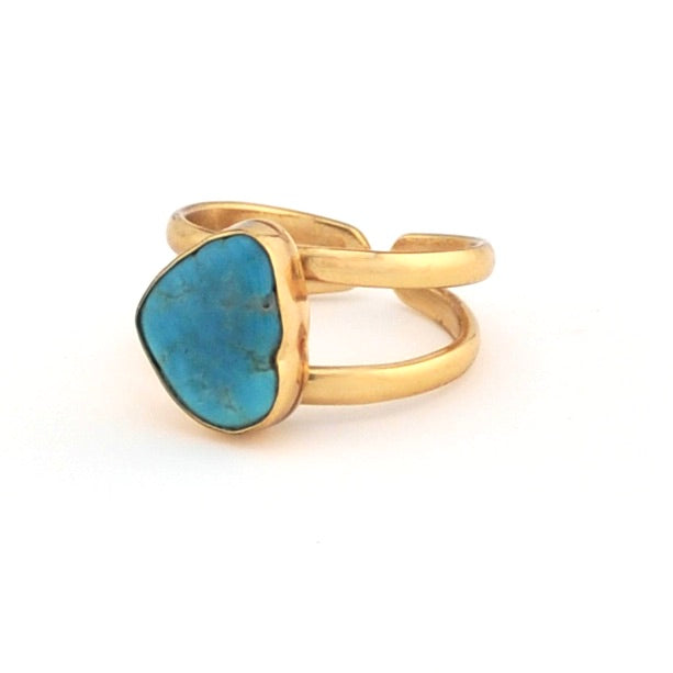 Gold ring with a blue stone on a white background
