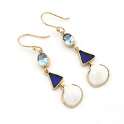 Pair of gold earrings with blue and white stones on a white background