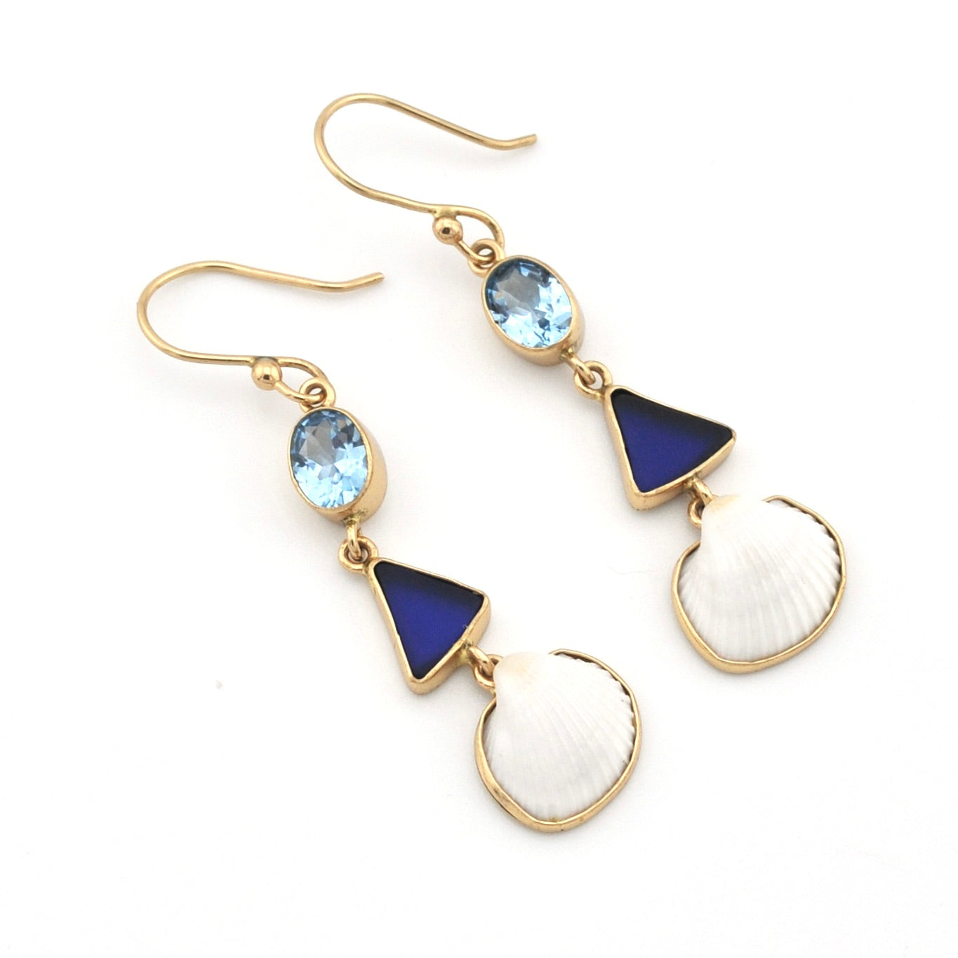 Pair of gold earrings with blue and white stones on a white background