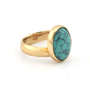 Gold ring with turquoise on white background
