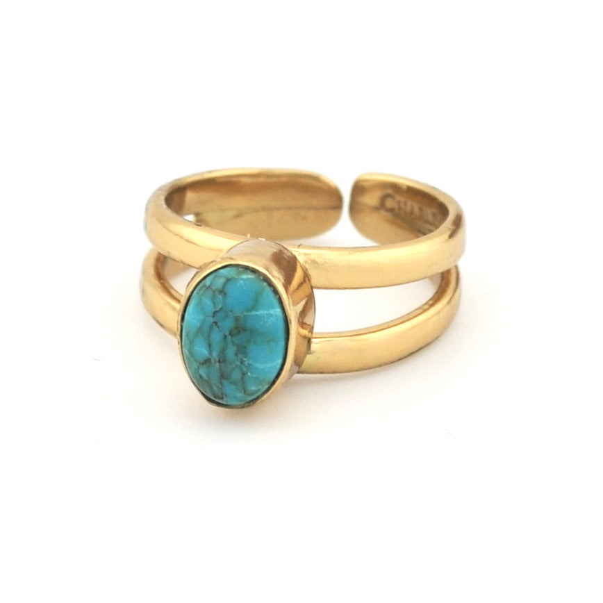 Turquoise with gold ring setting on white background