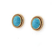 Pair of gold earrings with turquoise stones on a white background