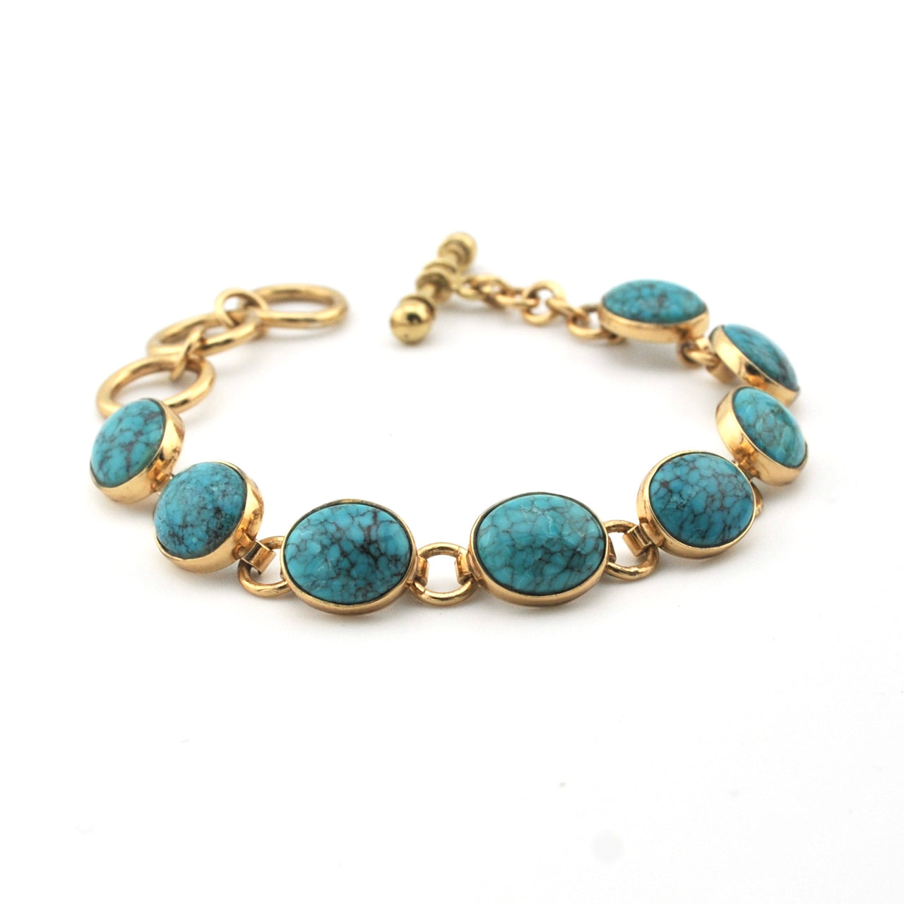 Gold bracelet with turquoise stones on a white background
