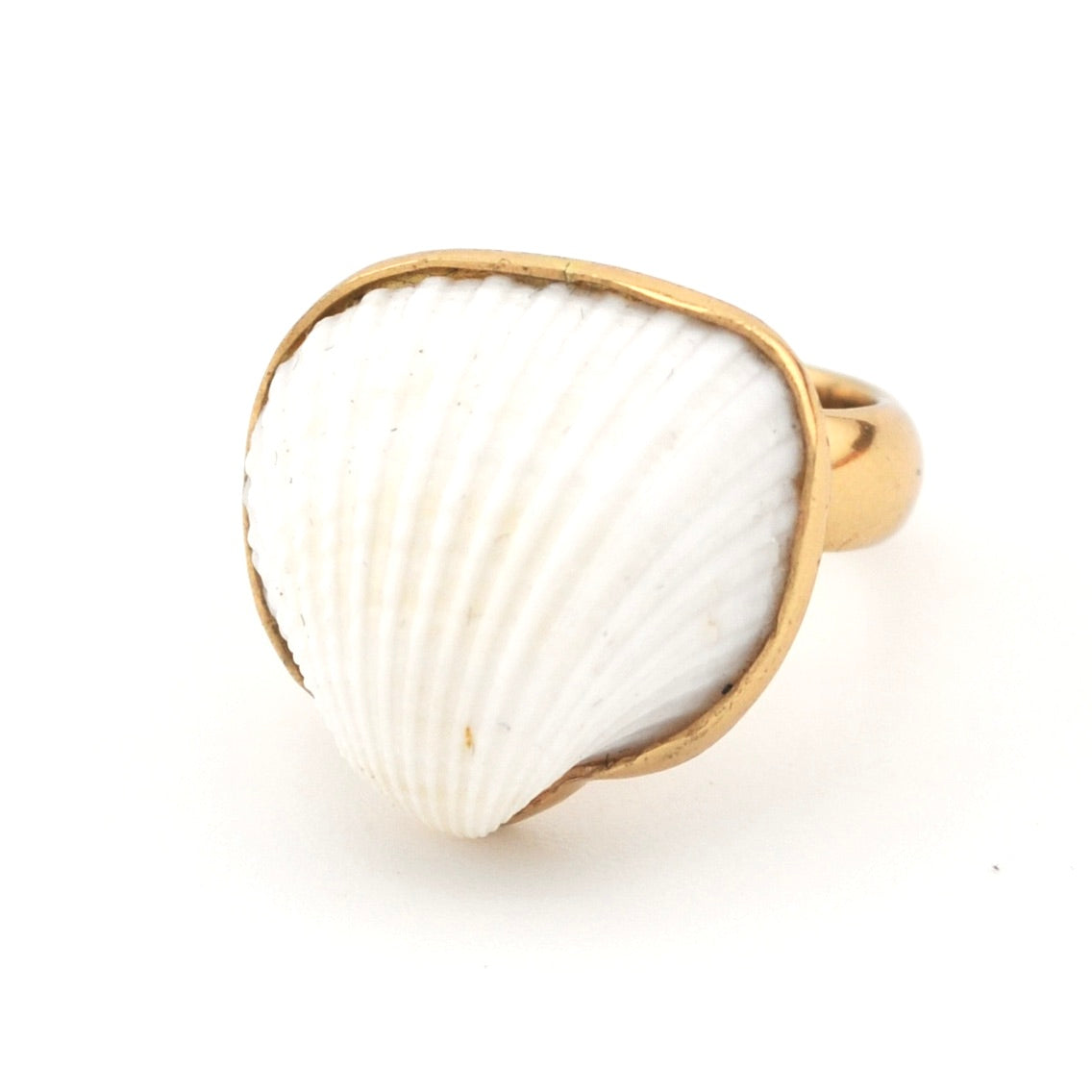 Ring with a white shell-like center and gold band on a white background