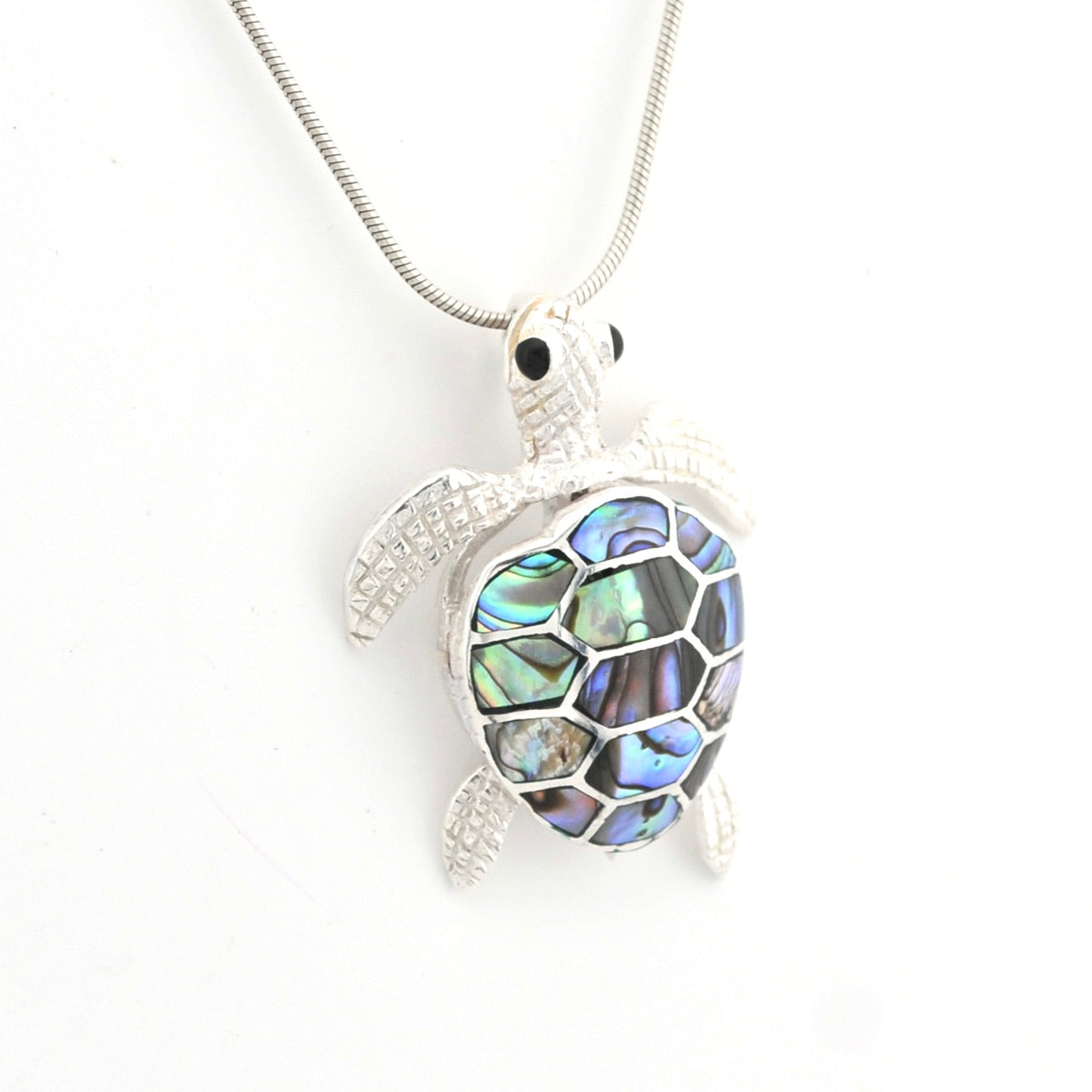 Tortoiseshell turtle pendant on a white background