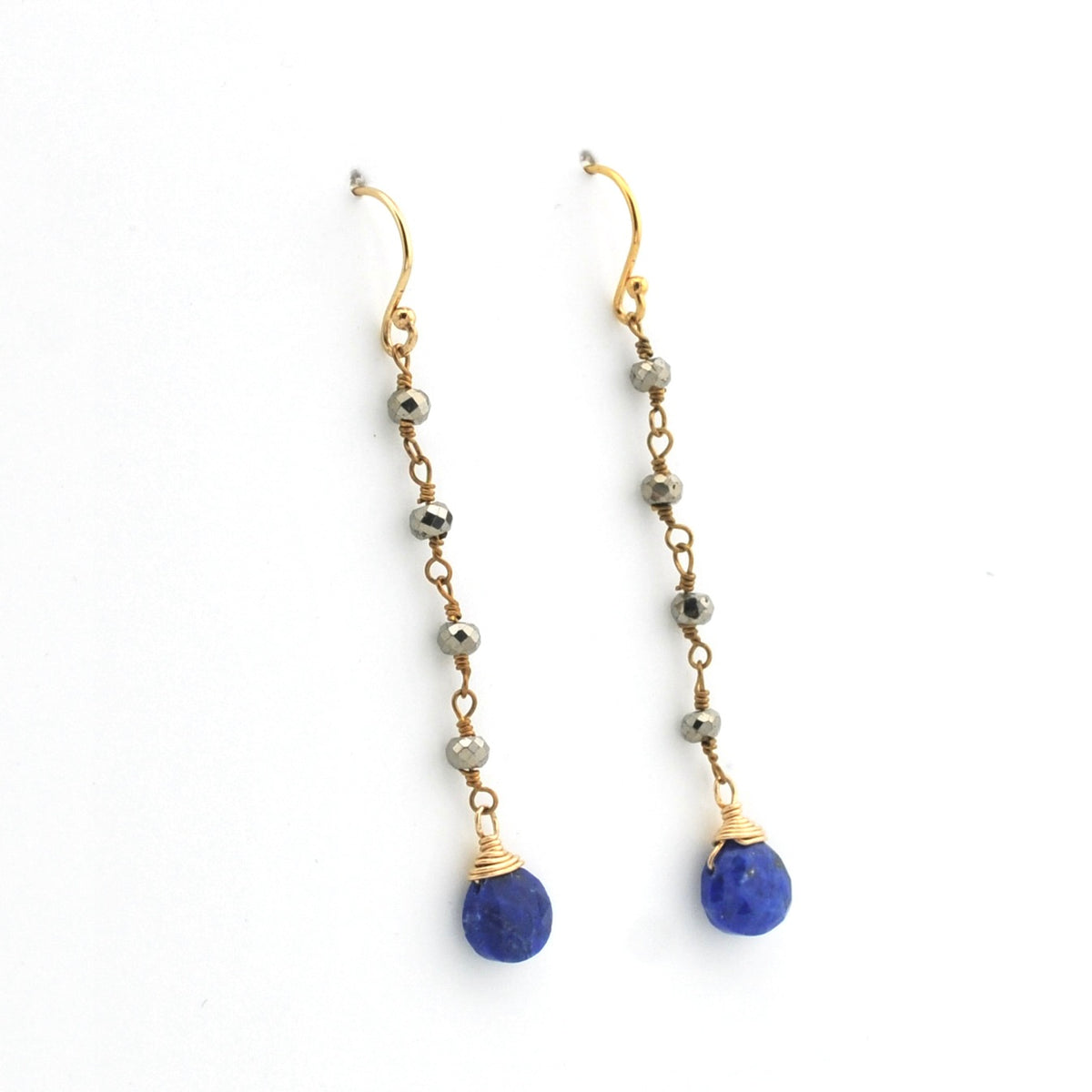 A pair of gold drop earrings with faceted beads and a teardrop-shaped blue lapis lazuli stone dangle, shown on a plain white background.