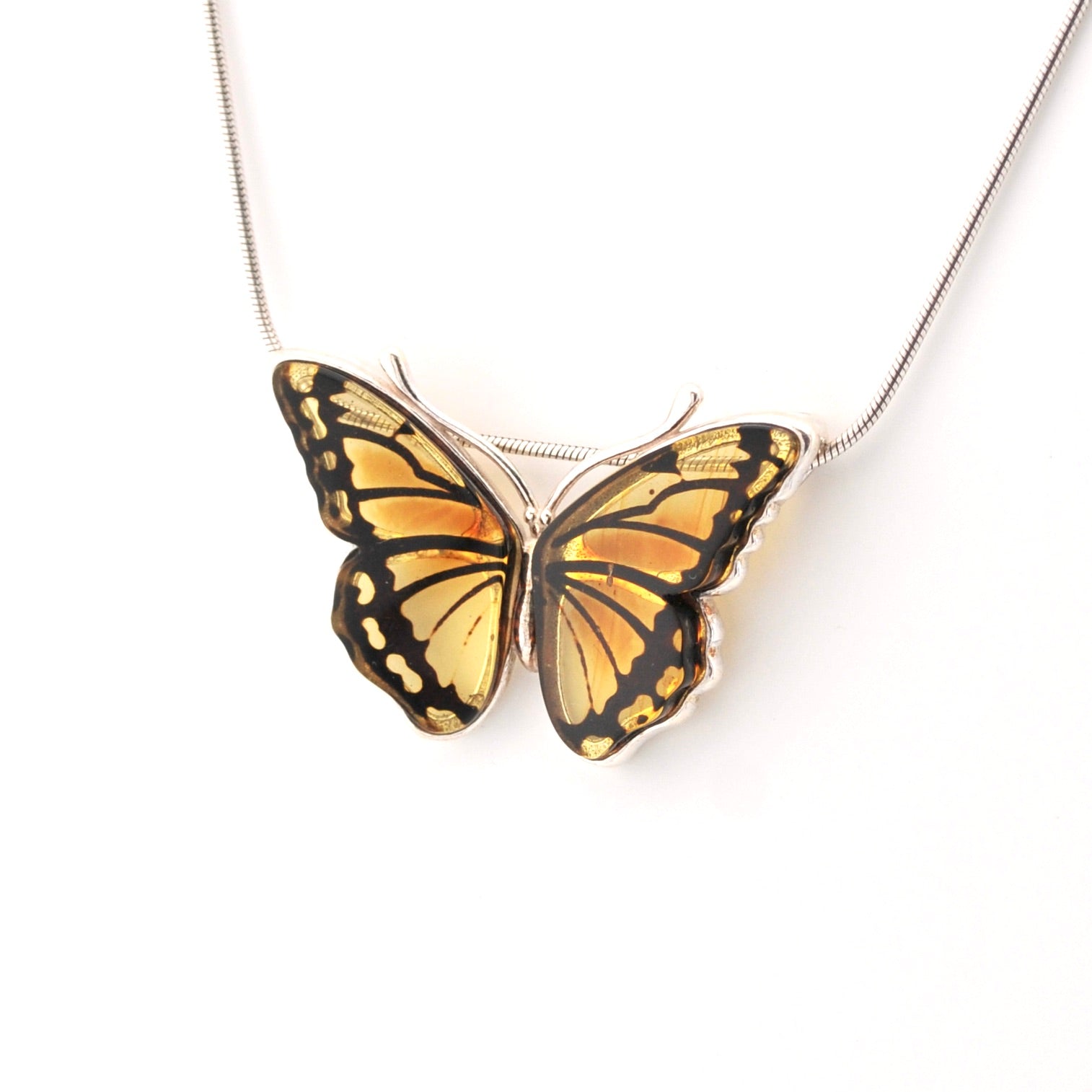 Butterfly-shaped pendant on a chain against a white background